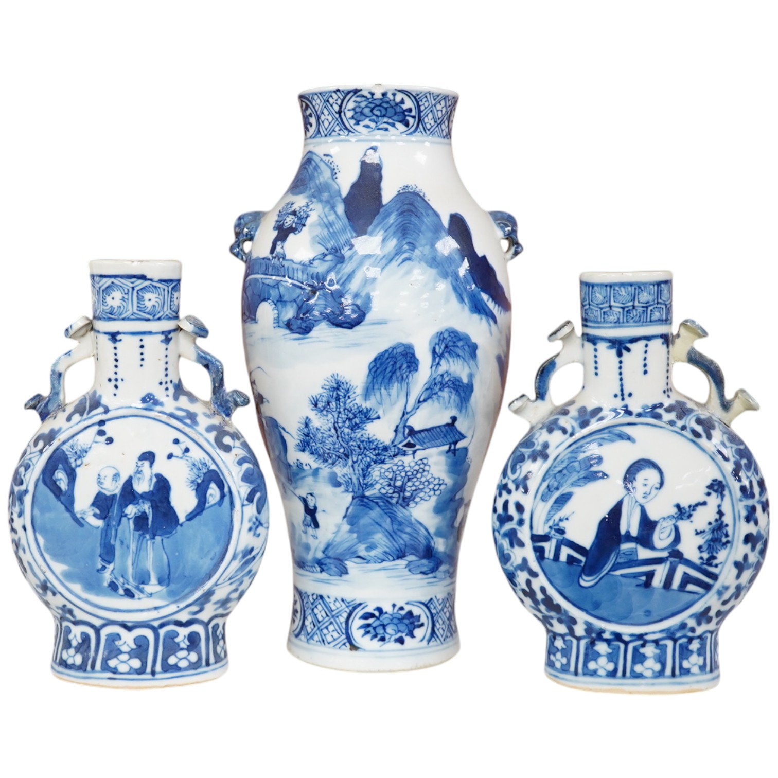 Late 19th century Chinese vases; pair of small Chinese blue and white moon flasks and a larger Chinese blue and white landscape vase, larger vase 22cm high. Condition - one moon flask handle restored, other items fair